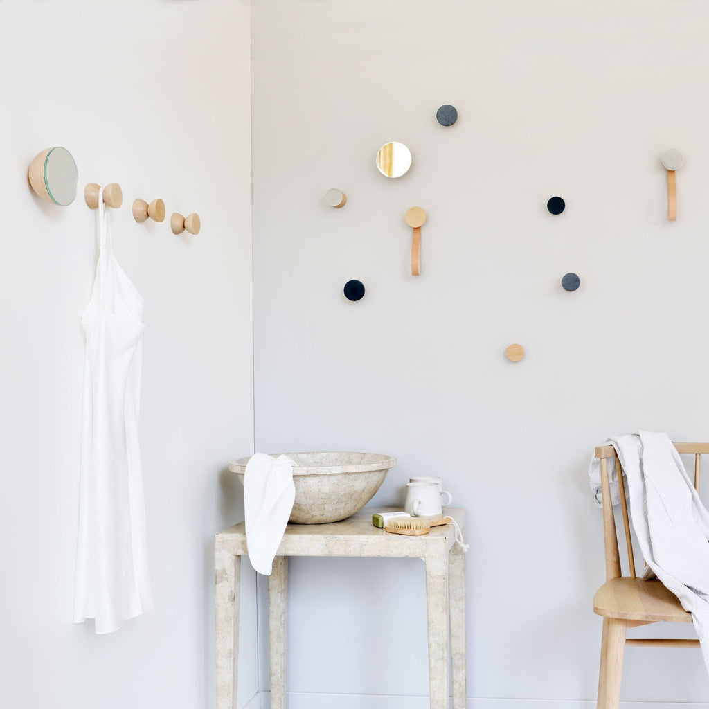 1. Lifestyle image of beech wood wall hooks by 5mm Paper in a modern room setting with various hooks on the wall