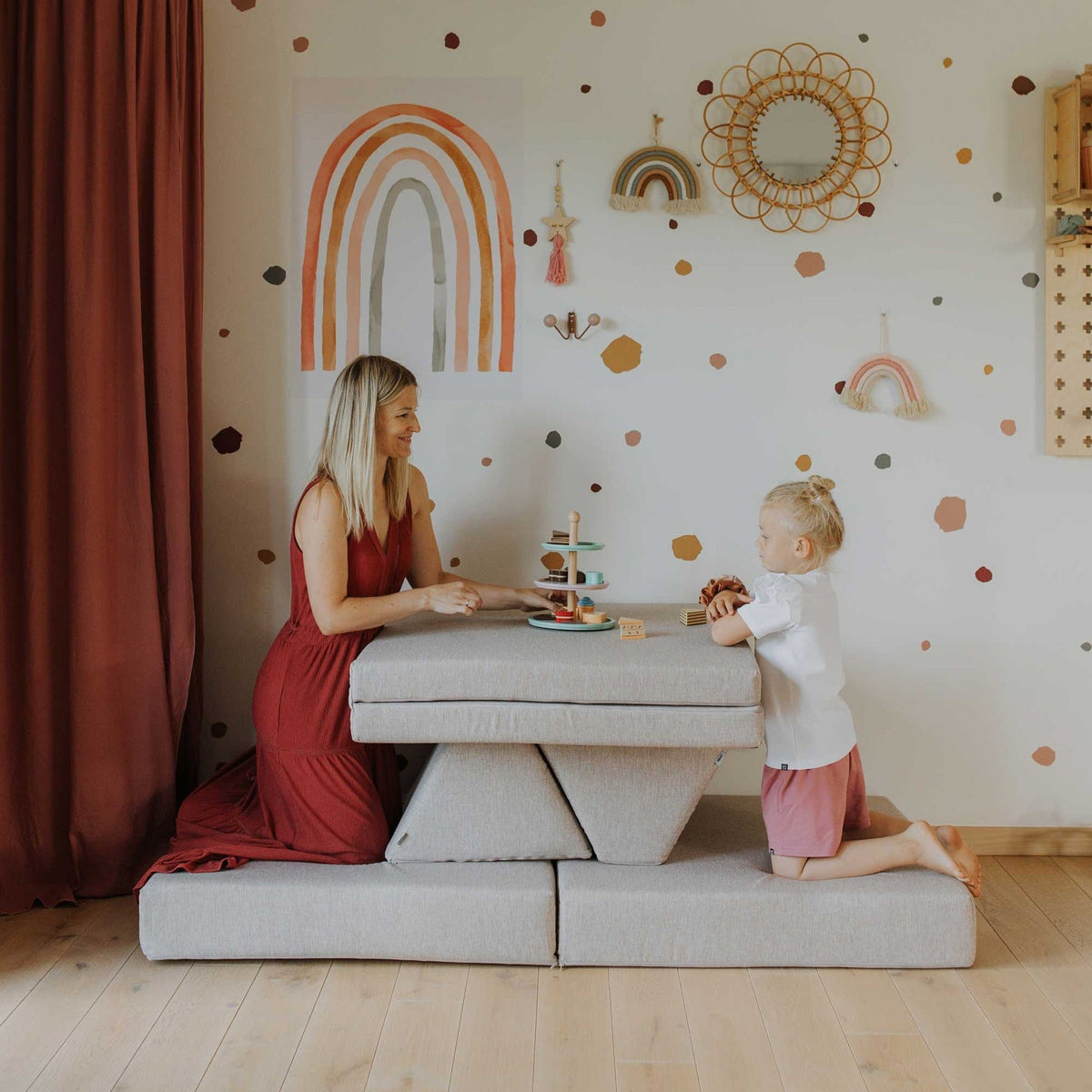 3. Woman and child using beige Monboxy play mattress set as a table in a colorful room