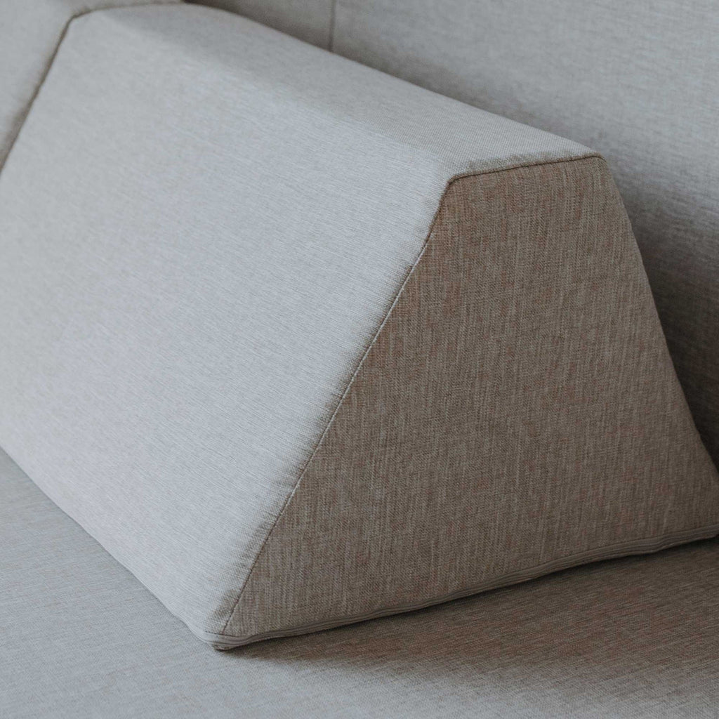 5. Close-up of trapezoidal pillow from beige Monboxy play mattress set showing fabric texture