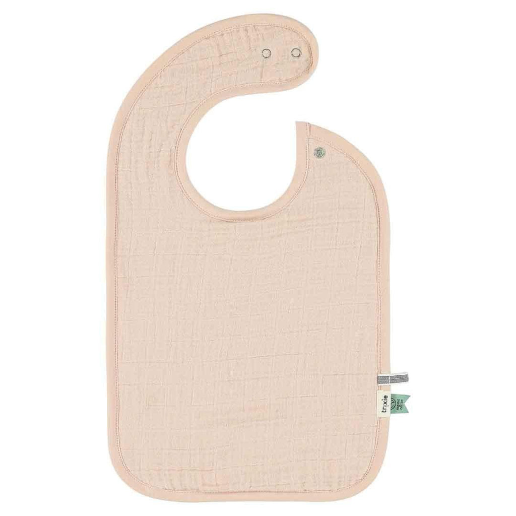 2. Single solid color Trixie Baby bib in light pink with adjustable snaps, made from organic cotton