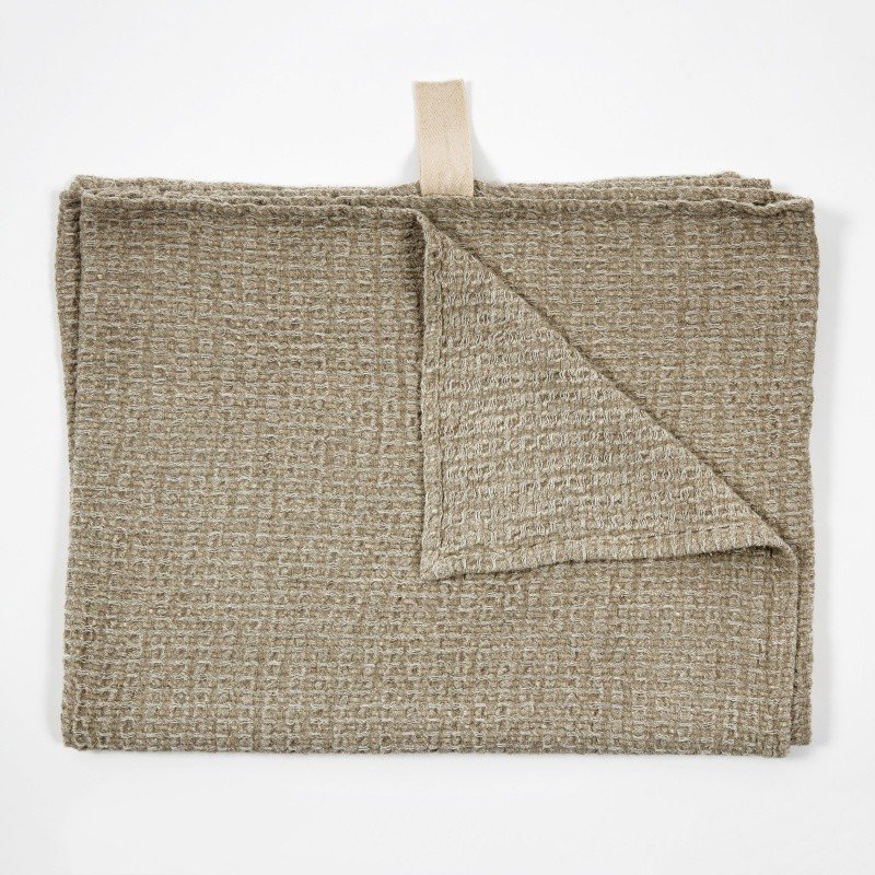 6. Grey textured linen towel laid flat with visible cotton hanger on white background