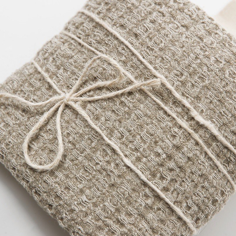 7. Folded grey textured linen towel tied with string showing fabric texture