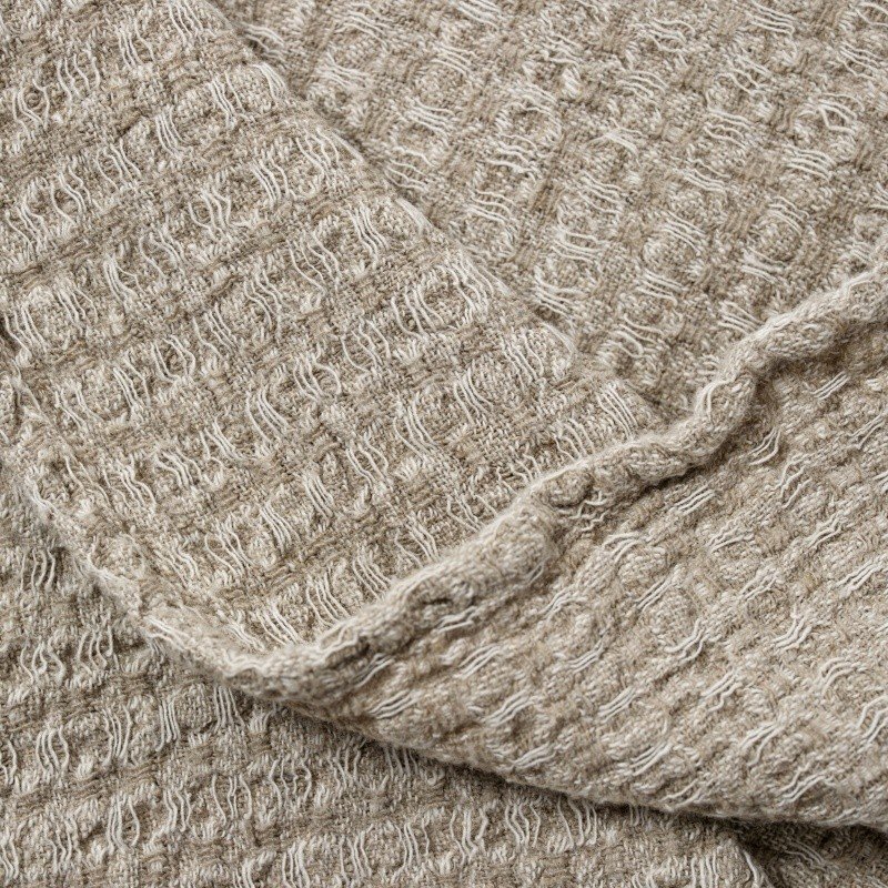 5. Close-up of grey textured linen fabric showing detailed weave pattern