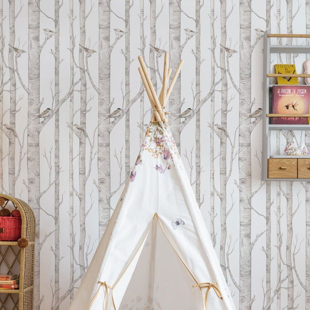 1. Children's room with birch forest wallpaper featuring white, gray, and brown birch trees and birds, with a white teepee and wooden shelf