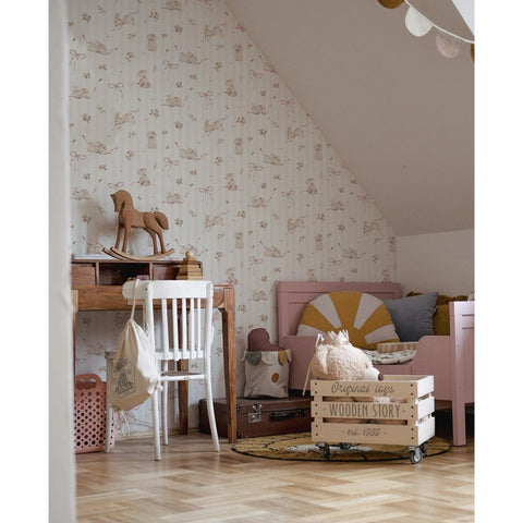 1. Playroom with pink rabbits on stripes wallpaper, wooden toys, and pink furniture