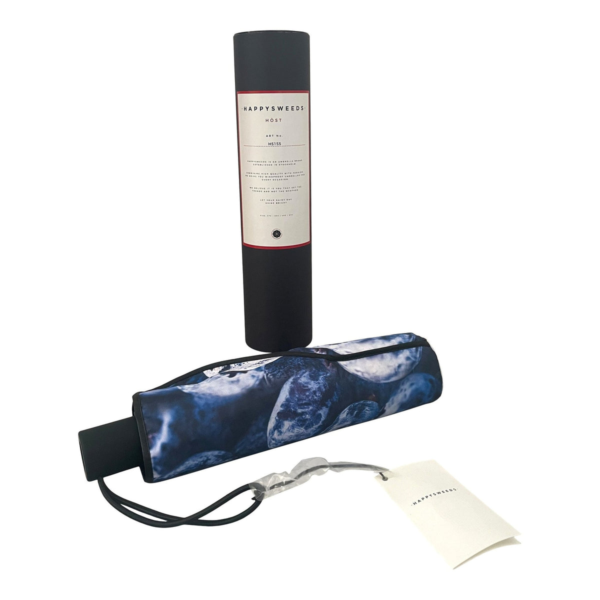 4. Flat lay of Blåbär umbrella with blueberry print and packaging showing handle and strap