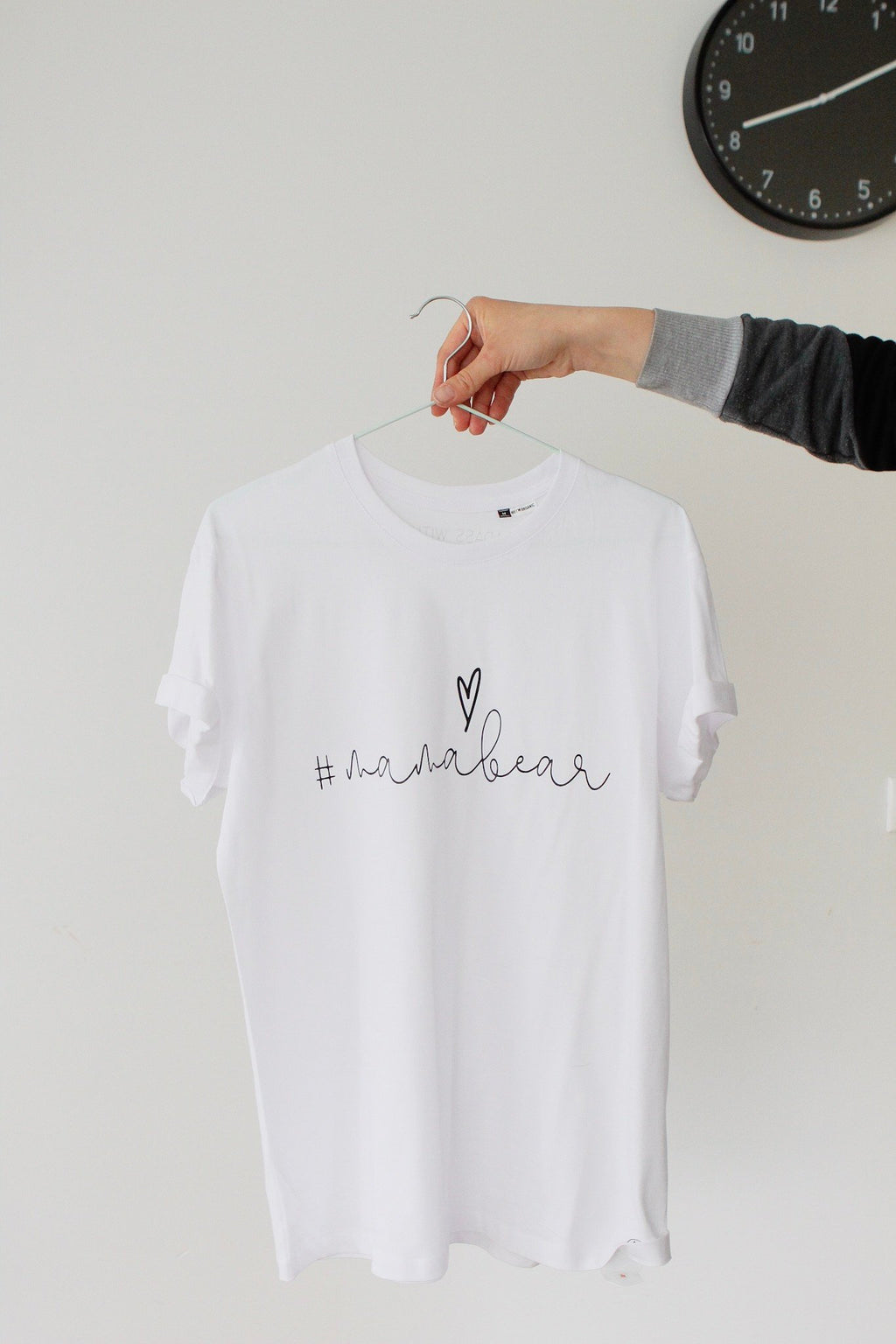 1. White Mamabear T-shirt by Black Giraffe Brand with rolled-up sleeves, shown on hanger