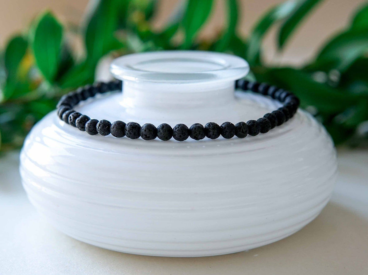3. Men's Black Lava Anklet by Canary Lava displayed on white ceramic, highlighting handcrafted design