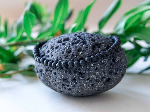 5. Men's Black Lava Anklet by Canary Lava on lava rock, showcasing texture and durable construction