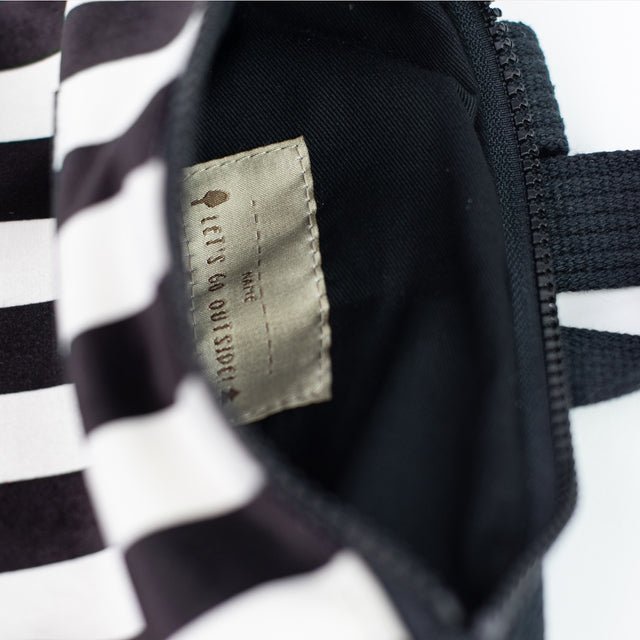 6. Close-up of Muni black and white striped backpack interior showing label