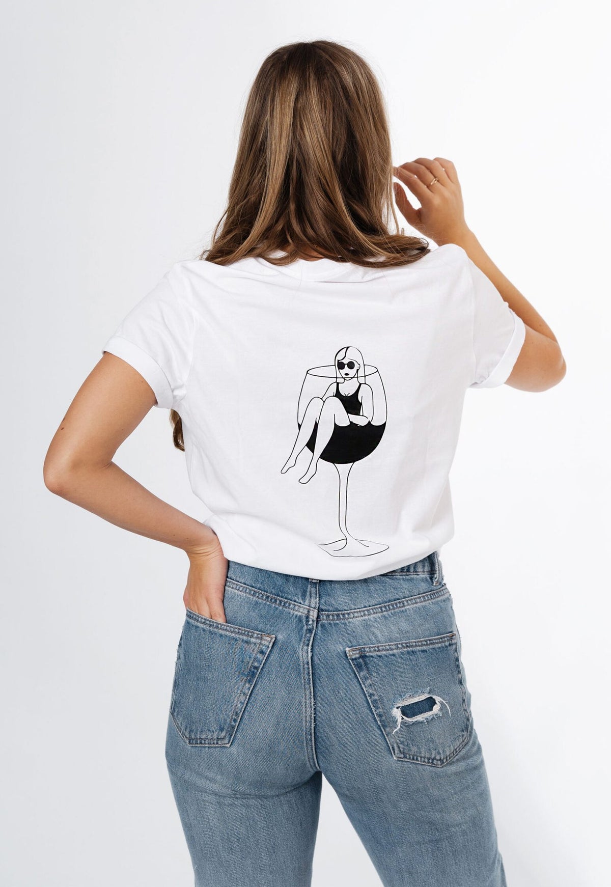 6. Women's white T-shirt by Black Giraffe Brand, featuring wine glass illustration on back, shown in lifestyle setting