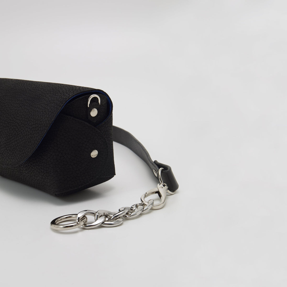 7. Side view of Daz Studio black leather shoulder bag with chain strap and magnetic flap closure