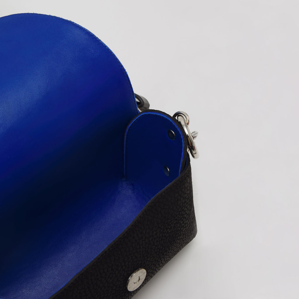 4. Interior view of Daz Studio black leather shoulder bag showing royal blue leather lining