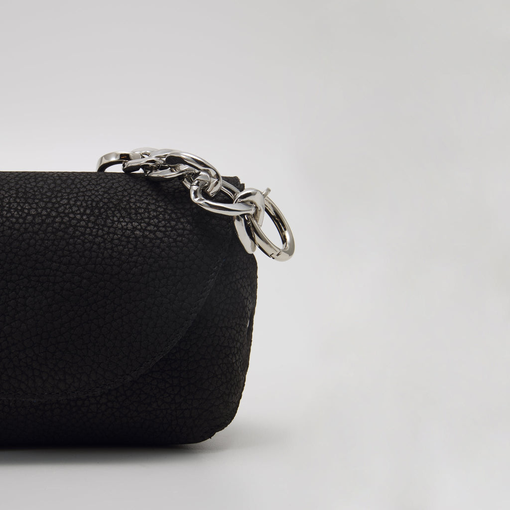5. Close-up of Daz Studio black leather shoulder bag with silver-toned hardware detail