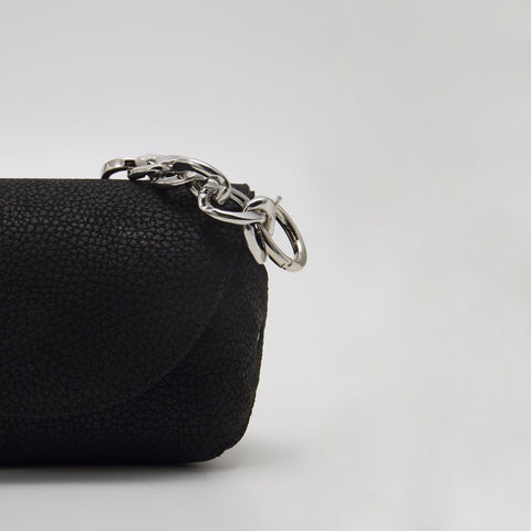5. Close-up of Daz Studio black leather shoulder bag with silver-toned hardware detail