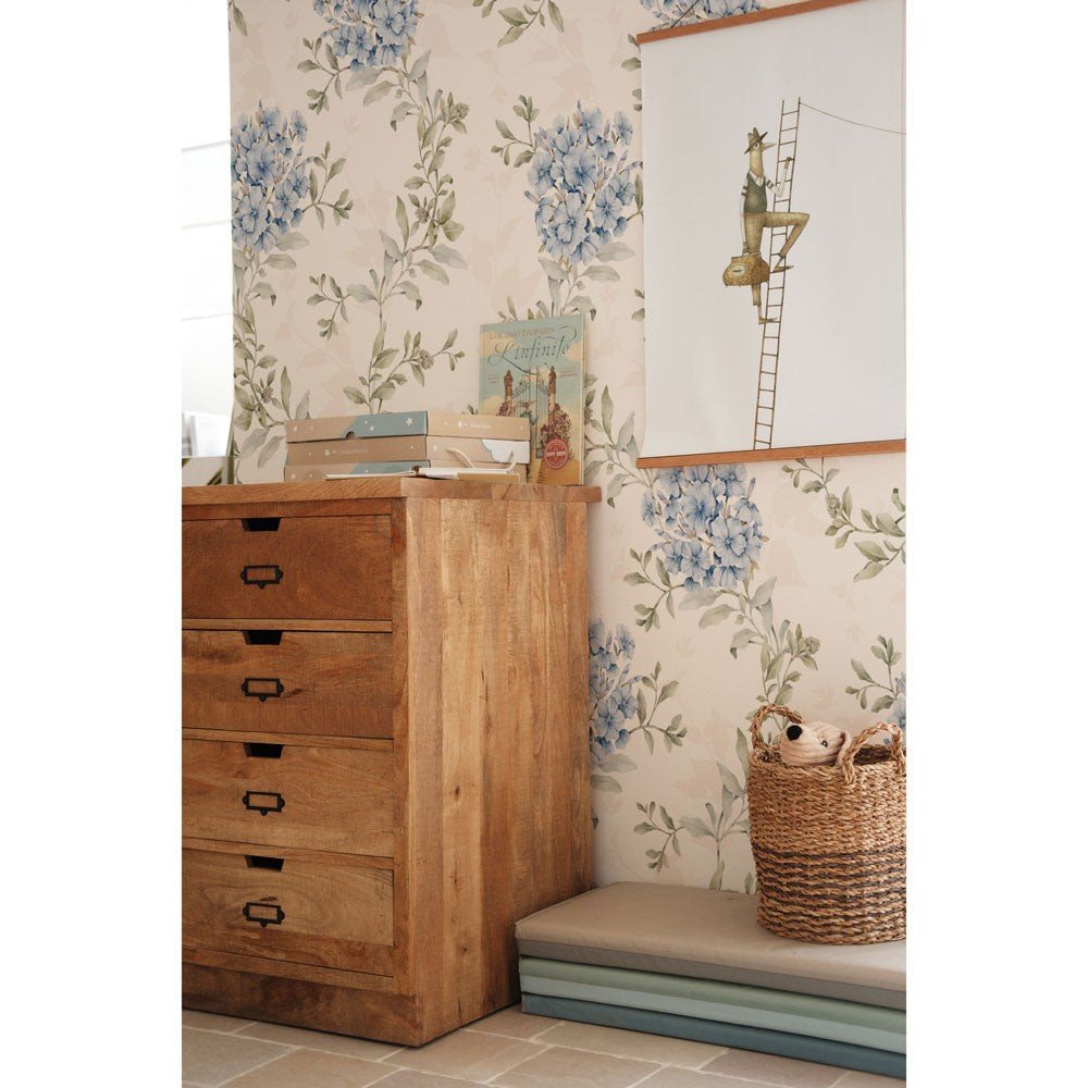 1. Room with blue floral wallpaper, wooden chest of drawers, and wicker basket, creating a cozy setting