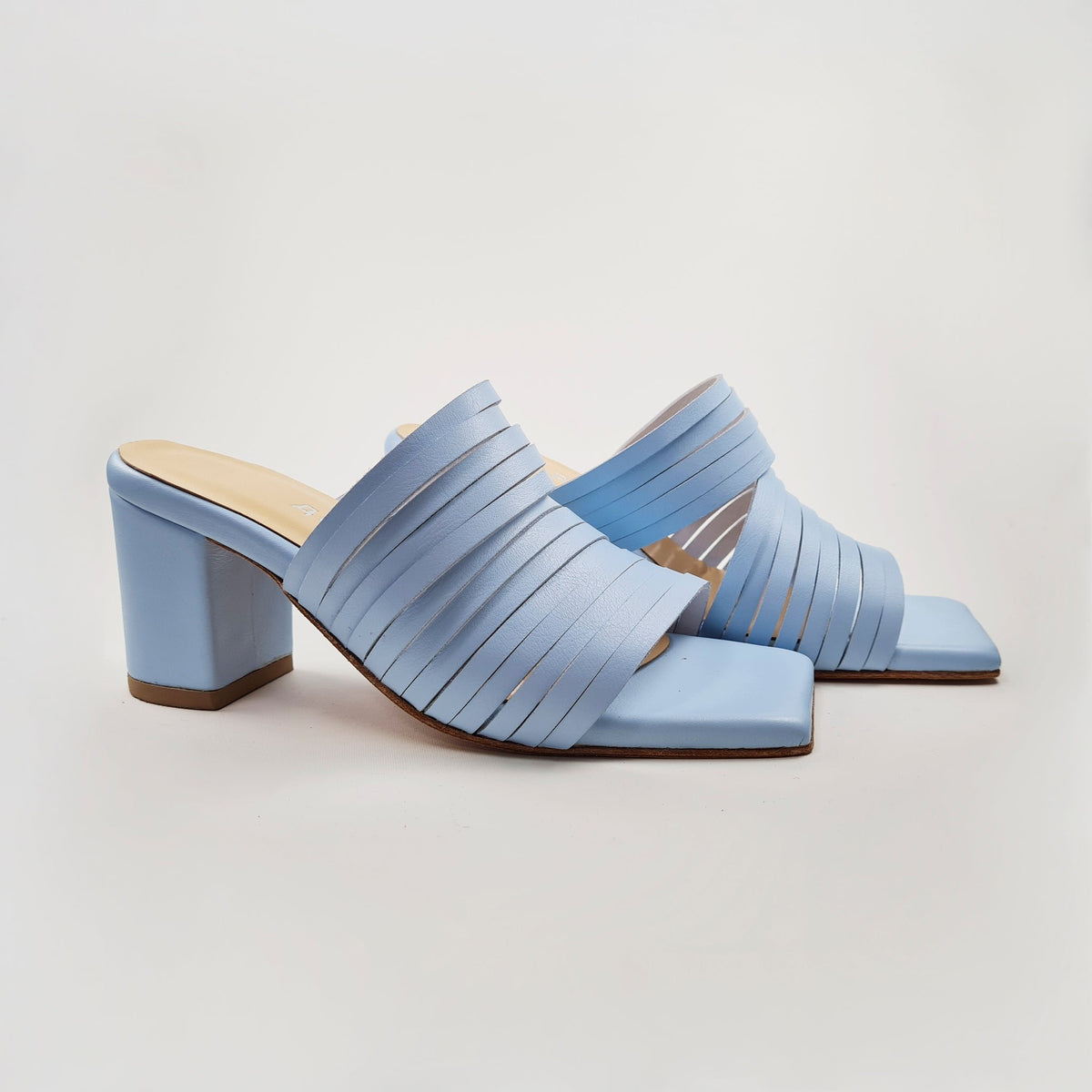 6. Studio image of Daz Studio's light blue strappy leather sandals, emphasizing heel height and design