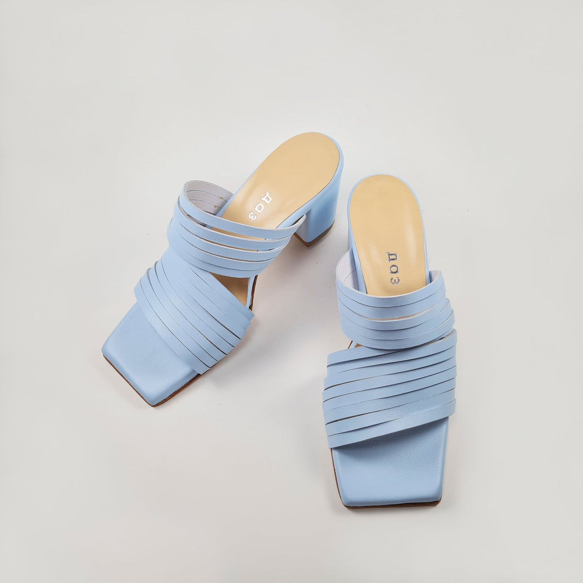 3. Side view of women's light blue leather sandals by Daz Studio, highlighting strappy design and squared toe