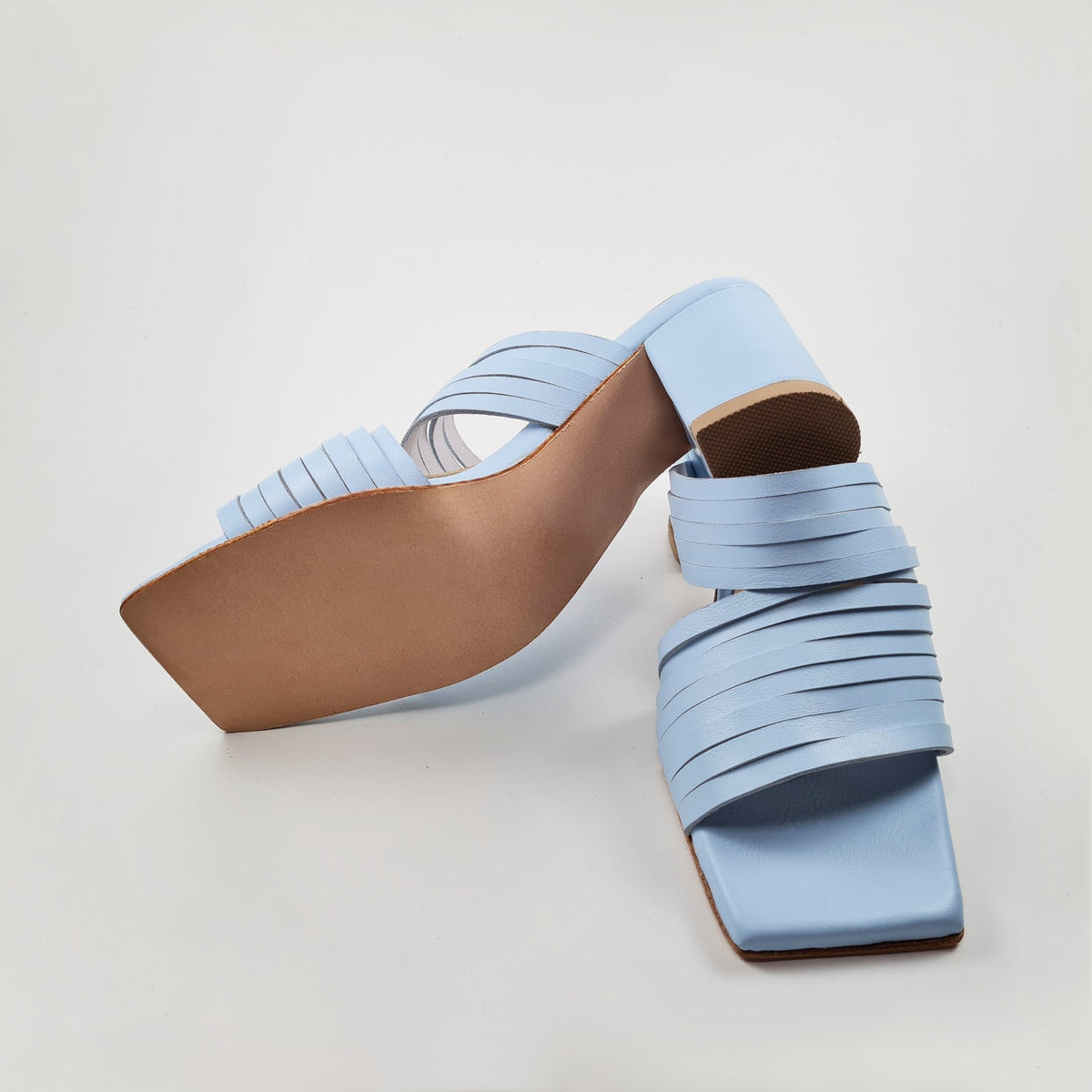4. Overhead view of Daz Studio's light blue leather sandals, showing strappy design and squared toe