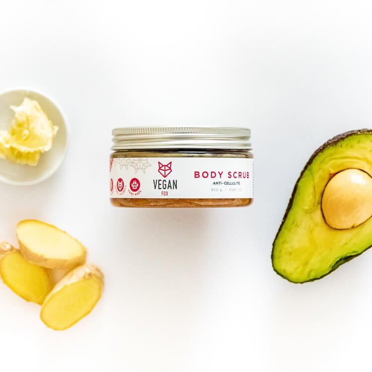 4. Three Vegan Fox body scrubs on bathtub edge with flowers, including Anti-cellulite Body Scrub Ginger