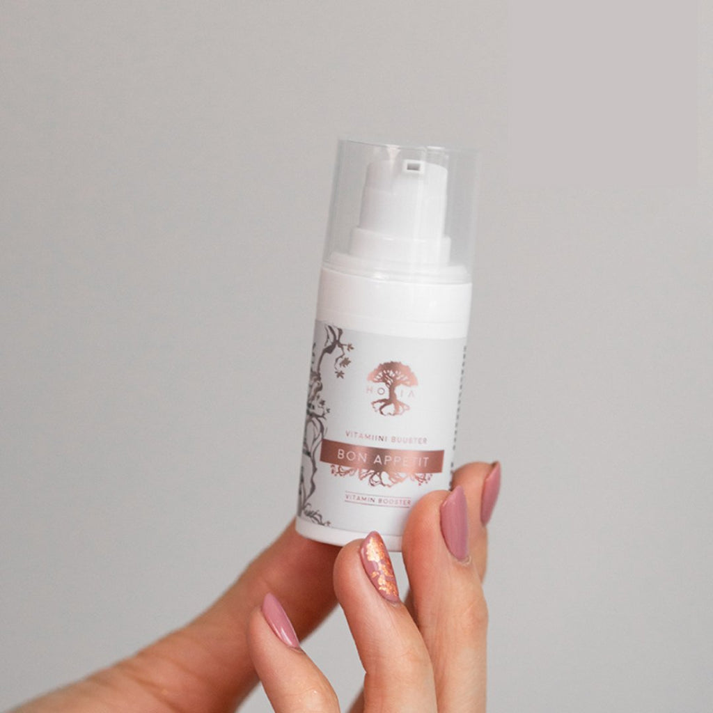 1. HOIA homespa Bakuchiol Vitamin Serum Bon Appetit held by a hand, showcasing the product's packaging and design