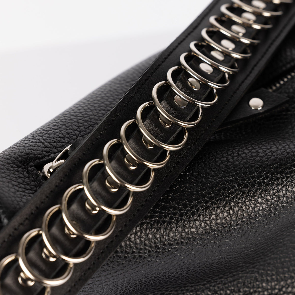 4. Detailed view of metal chain and leather texture on PYKOK Handbag Bona