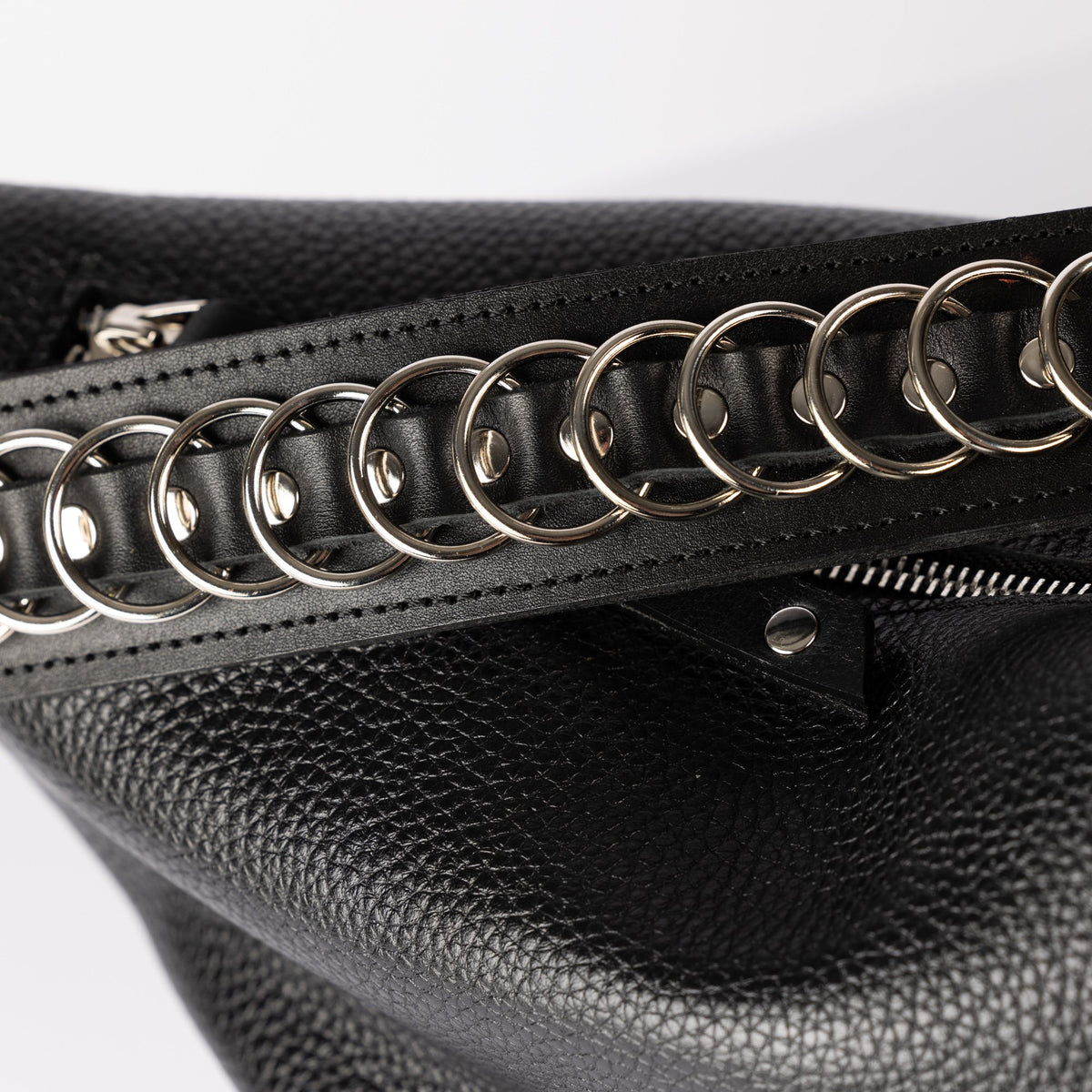 5. Close-up of zipper and metal chain strap on black leather PYKOK Handbag Bona