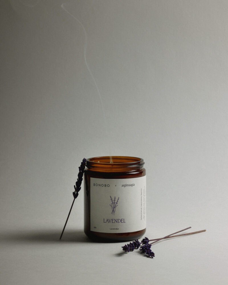 1. Bonobo lavender scented candle in amber glass jar with lavender sprigs on neutral background