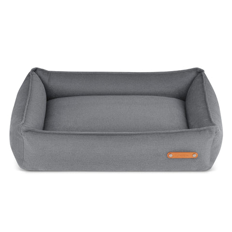 2. Grey rectangular dog bed with high sides and leather logo tag, designed by Labbvenn, shown on a white background highlighting its modern and functional design.