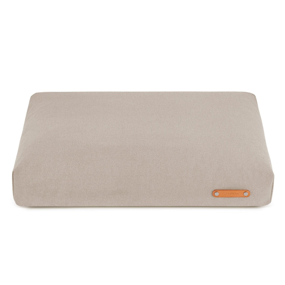 2. Beige Bosca dog cushion by Labbvenn with leather logo tag, shown on a white background highlighting its sleek and modern design.