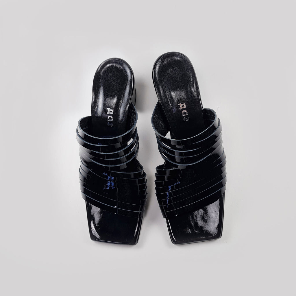 3. Top view of women's black strappy patent leather sandals with squared toe design