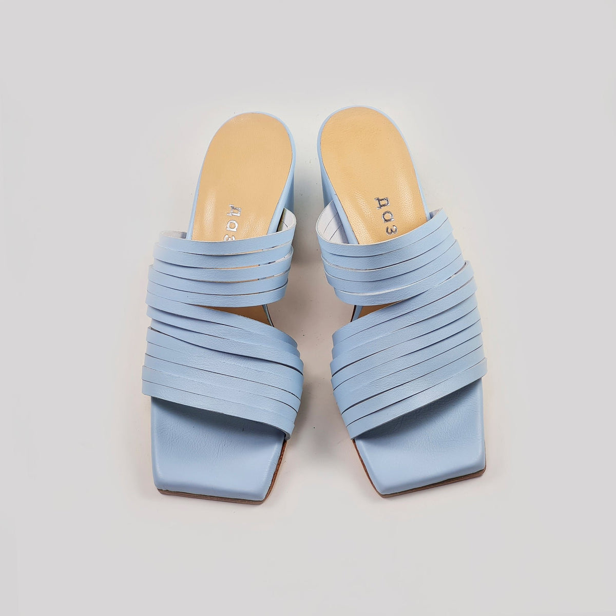 2. Studio shot of Daz Studio's handmade strappy leather sandals in light blue, featuring squared toe and 6 cm heel