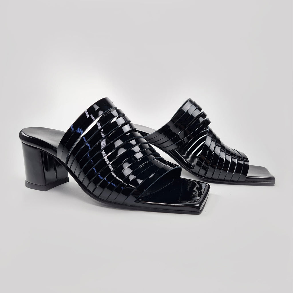 4. Side view of women's black patent leather sandals with 6 cm heel, highlighting strappy design
