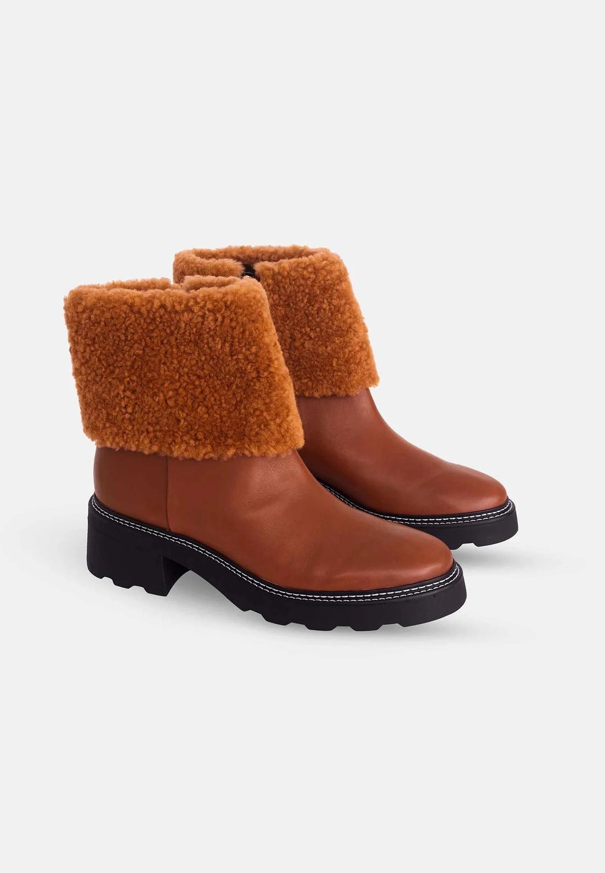 2. Pair of brown leather ankle boots with shearling detail and block heel on white background