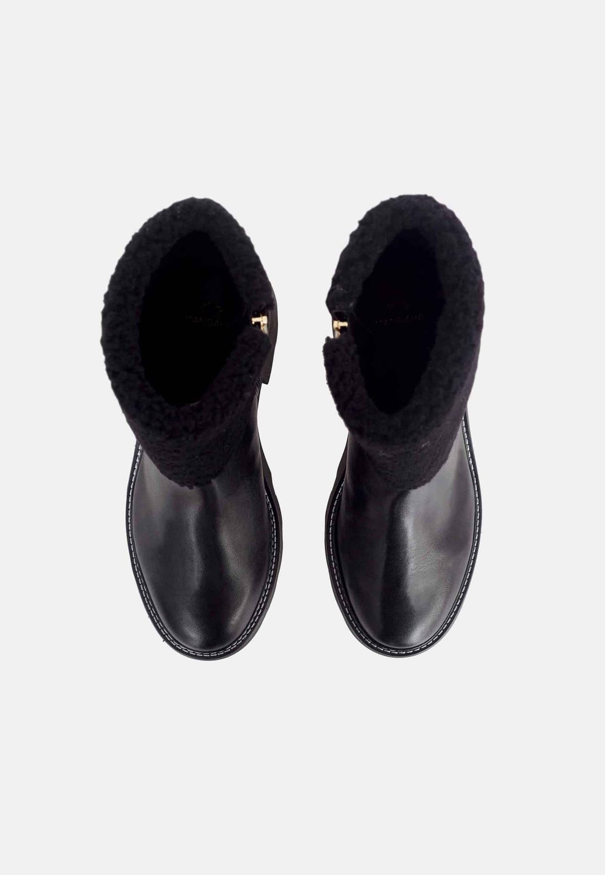 2. Top view of black leather ankle boots with shearling lining and block heel on a white background