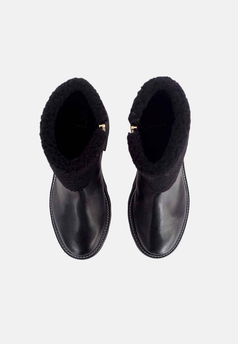 2. Top view of black leather ankle boots with shearling lining and block heel on a white background