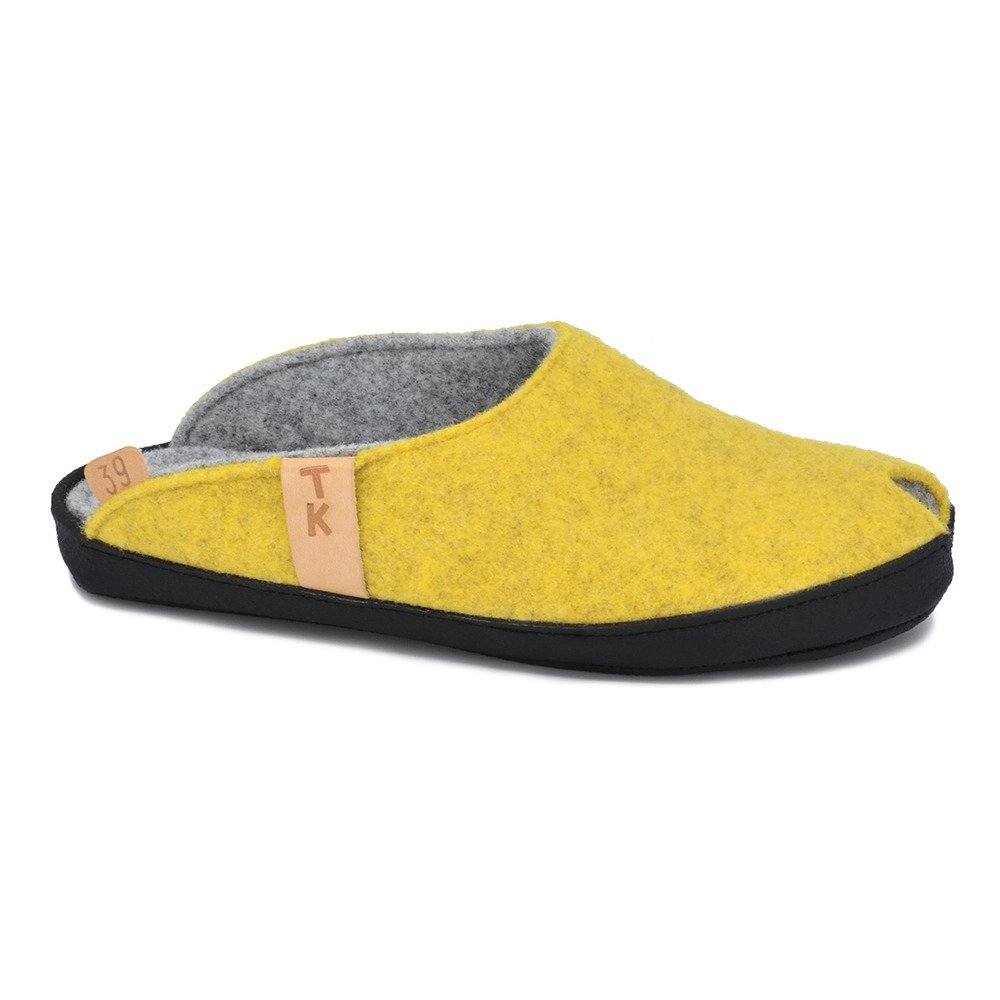 1. Studio shot of Omaking TOKU Brussels Slippers in vibrant yellow, featuring natural lambswool felt and black microfibre sole