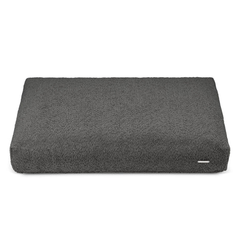 2. Anthracite Buklaa dog cushion in studio setting showing textured loop yarn surface and rectangular shape