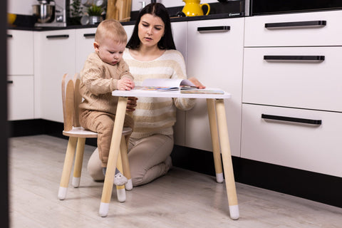 3. Woman and toddler using white bunny table and chair set in a modern kitchen, emphasizing family interaction and functionality