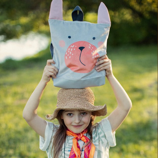 8. Muni Bunny kids backpack on pink background with flowers, highlighting cute design