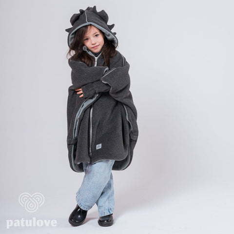 2. Girl in Patulove dragon-themed car poncho with hood, standing with arms crossed in studio setting