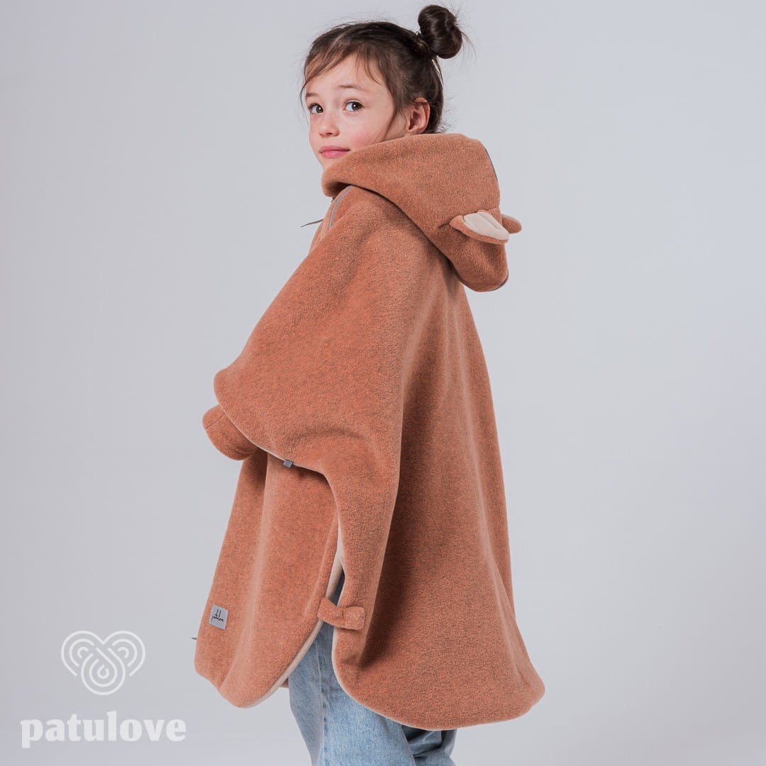 5. Side view of girl in Patulove fox car poncho with hood, showing back detail in studio
