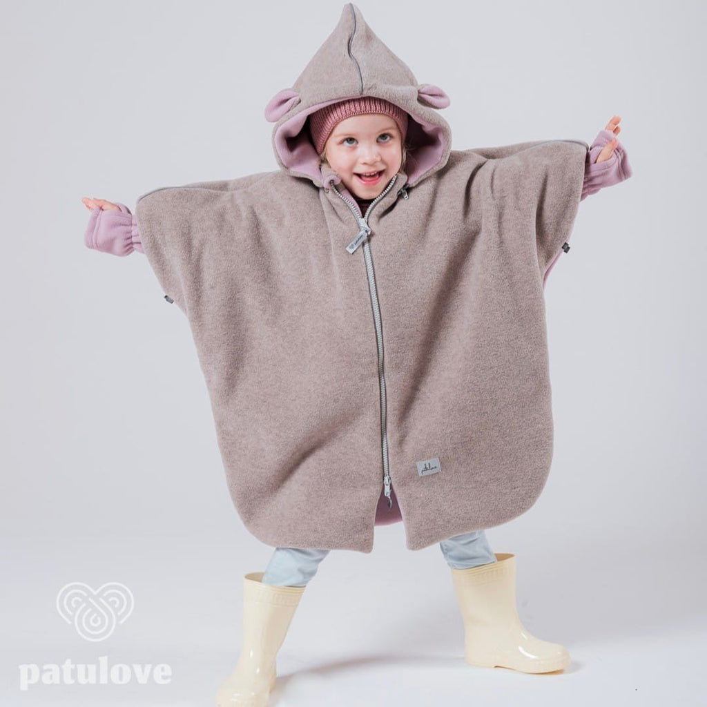 1. Child wearing Patulove pink lamb car poncho with hood and yellow boots, arms outstretched in studio setting