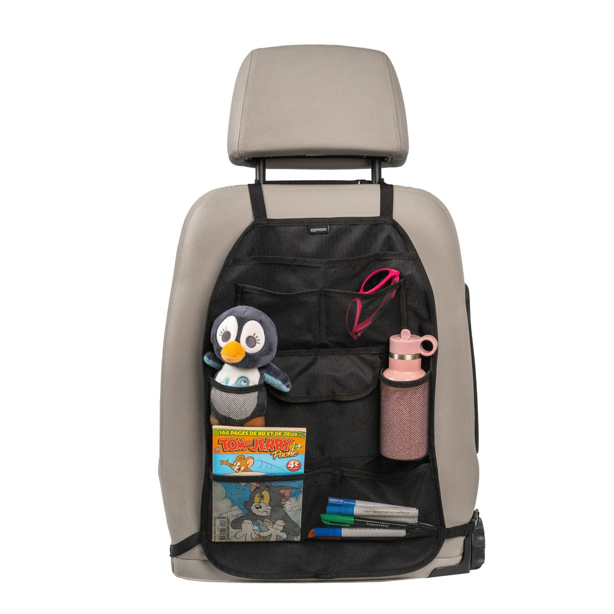 1. Car seat organizer with multiple pockets holding a toy, book, and water bottle on a beige car seat