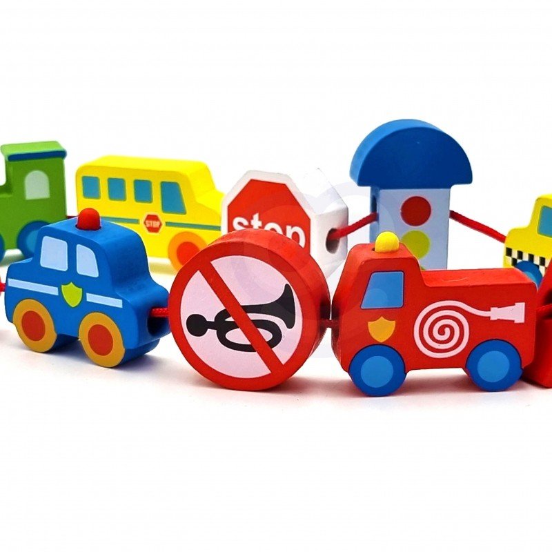 4. Wooden threading blocks with vehicles and road signs arranged in a line on a white background