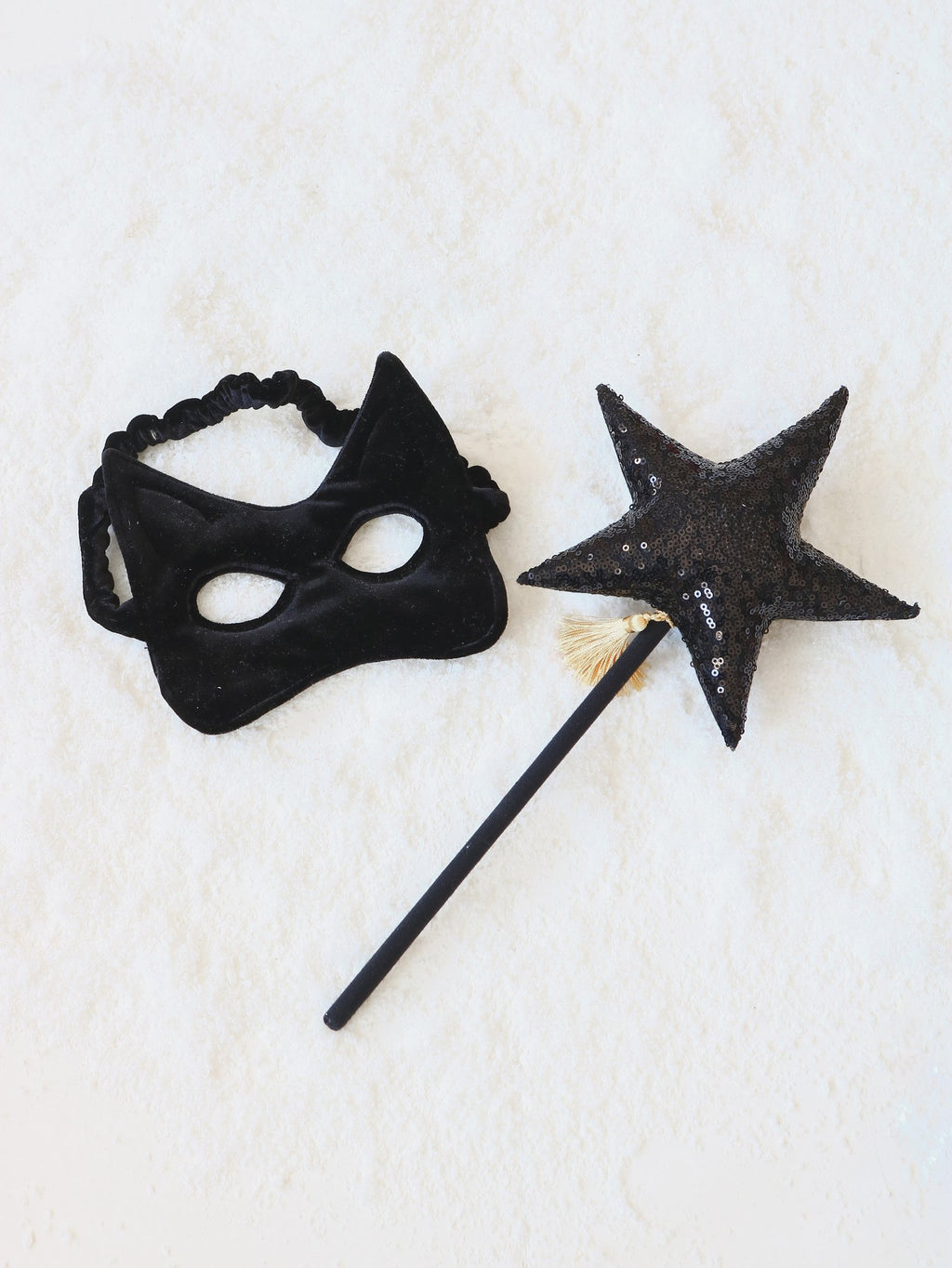 7. Black velvet cat mask with a matching star wand on a white background