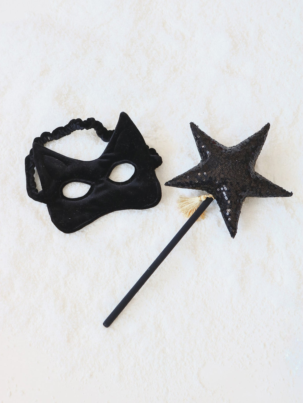 7. Black velvet cat mask with a matching star wand on a white background
