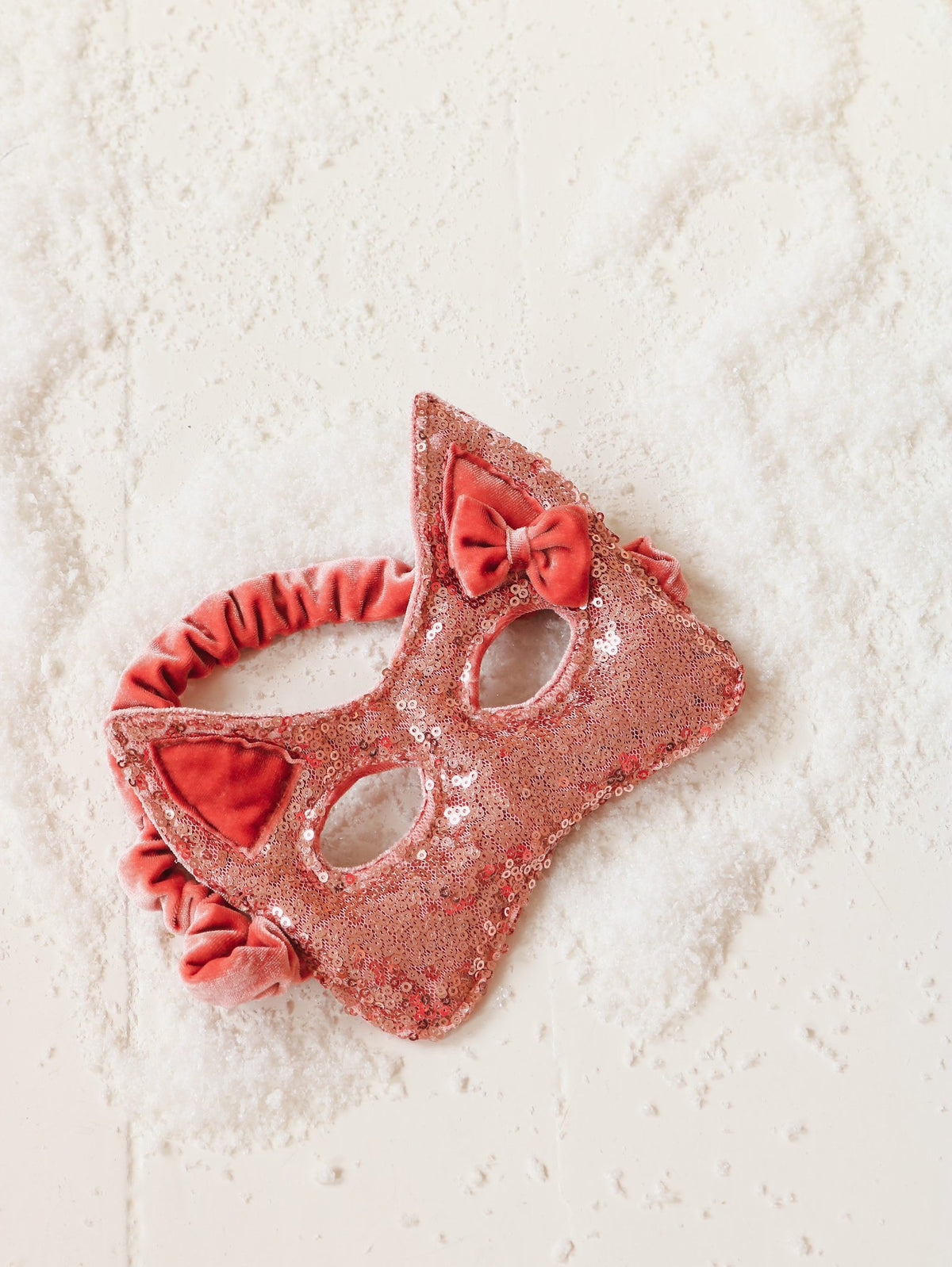 2. Pink sequin cat mask with velvet bow on textured white surface