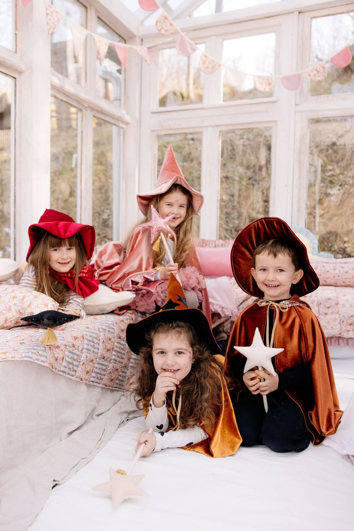 1. Four children in costume, playing in a bright room, one wearing a pink sequin cat mask