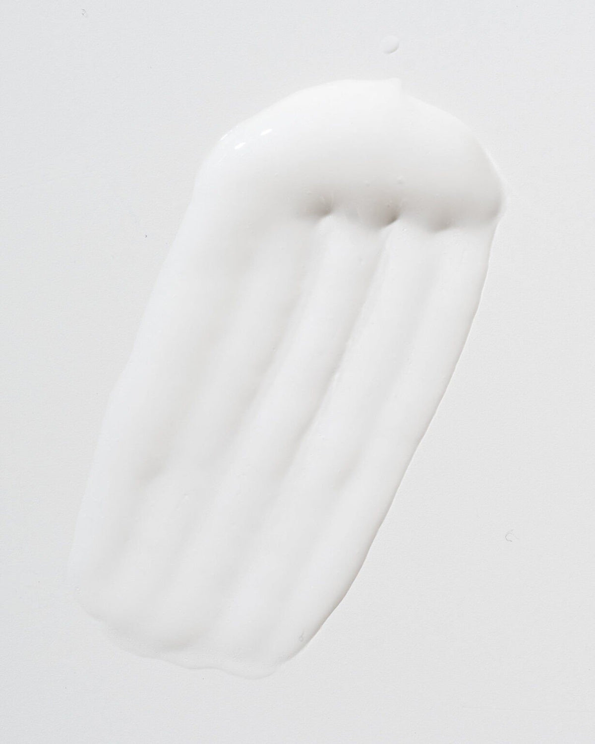 3. Close-up of LUUV Cellulite Treatment COSMOS cream texture on white background